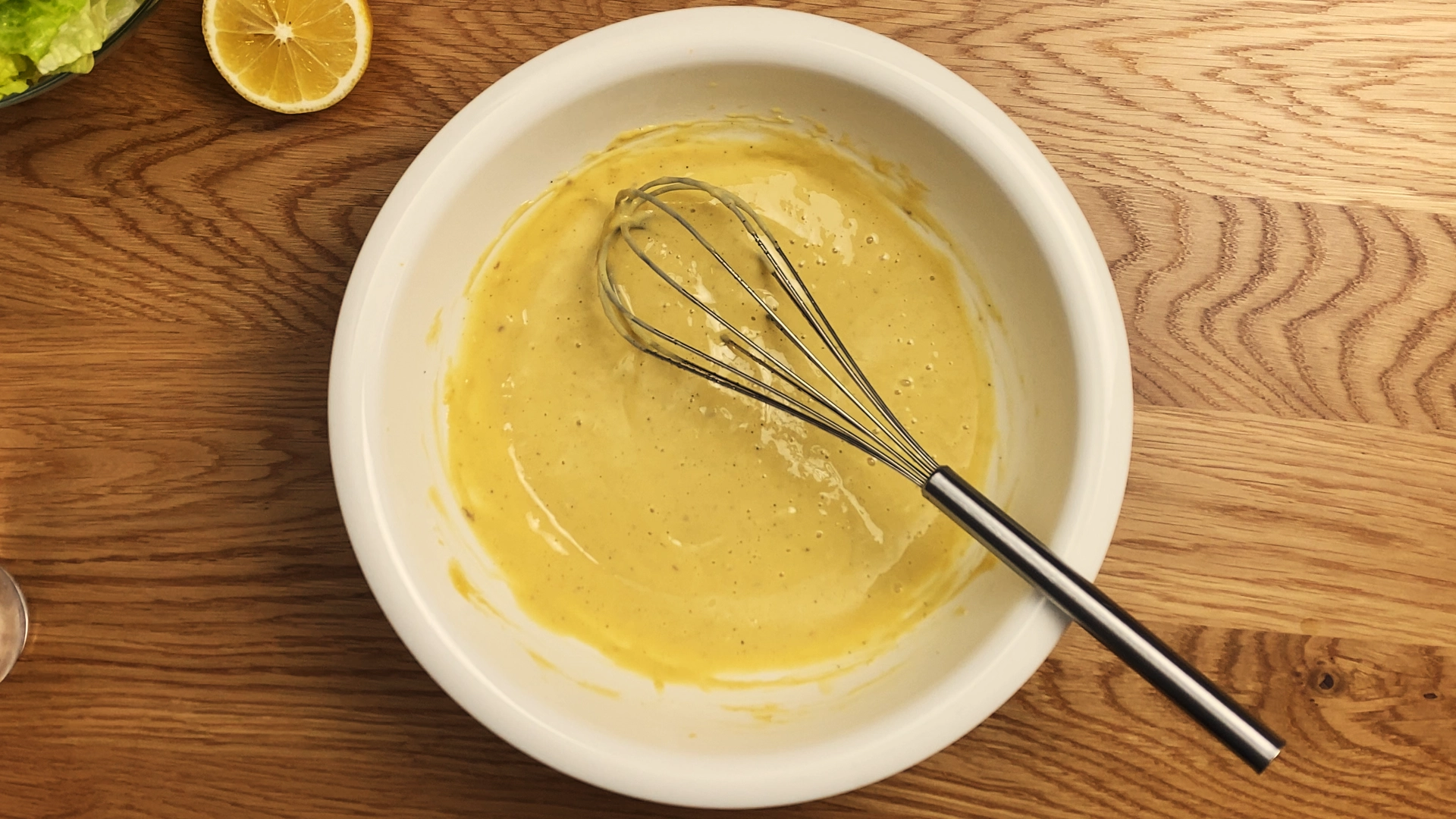 Creamy Caesar dressing with a smooth texture, made from garlic, anchovies, parmesan, and olive oil.